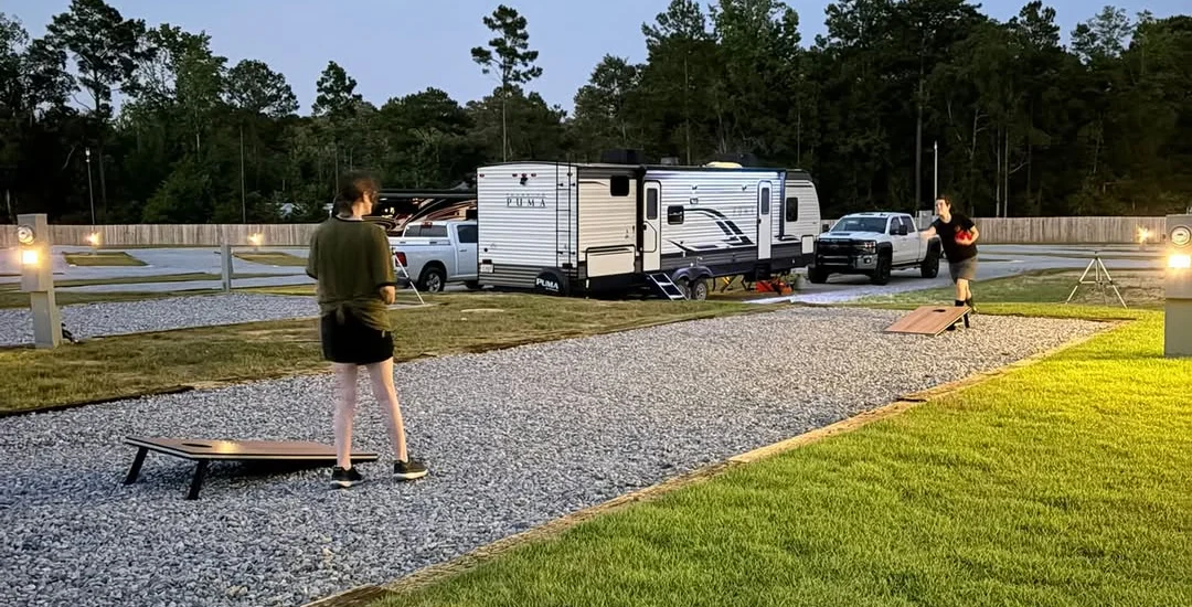 corn hole community activity at Unhitched North Pensacola RV Park in Pensacola, Florida